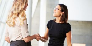 women networking handshake